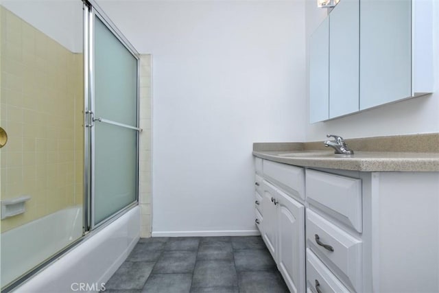 bathroom featuring vanity and shower / bath combination with glass door