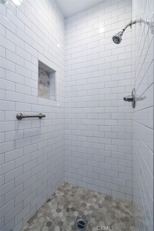 bathroom with a tile shower