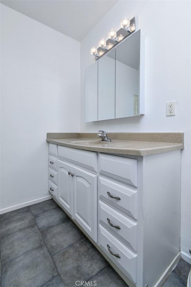 bathroom with vanity and baseboards