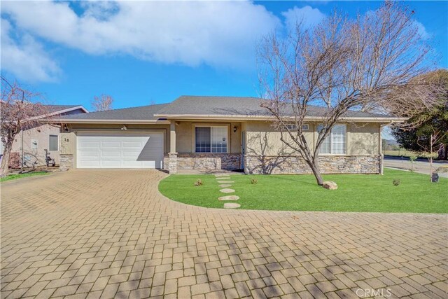 view of front of home with a garage and a front yard