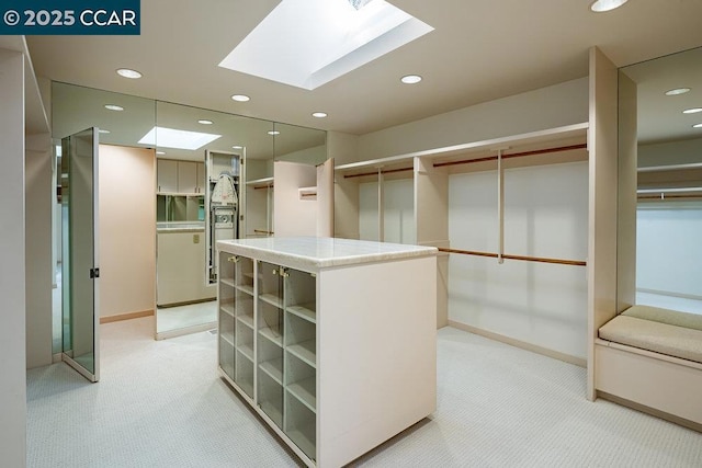 spacious closet with light carpet