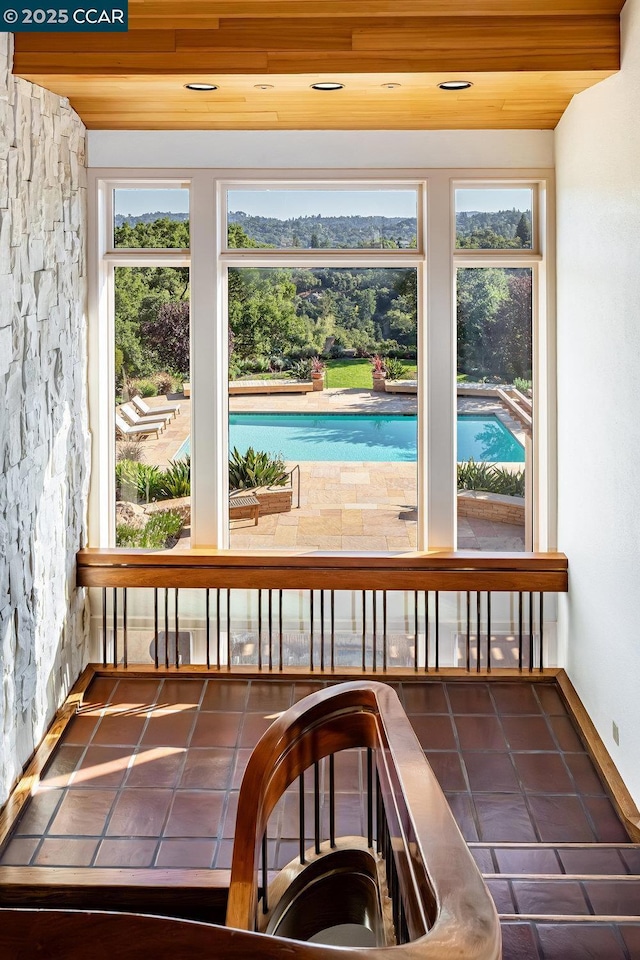 unfurnished sunroom featuring wood ceiling