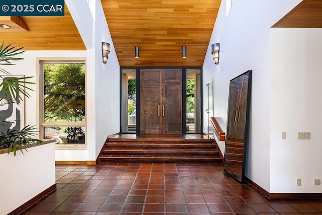 entrance foyer featuring a wealth of natural light, wooden ceiling, and high vaulted ceiling