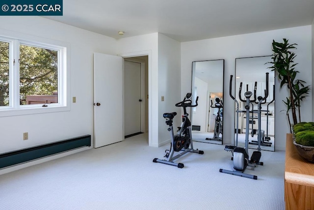 exercise area featuring carpet and a baseboard radiator