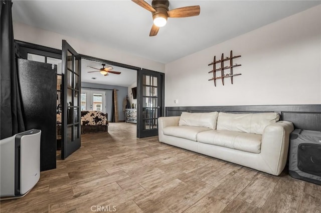 living room with ceiling fan and french doors