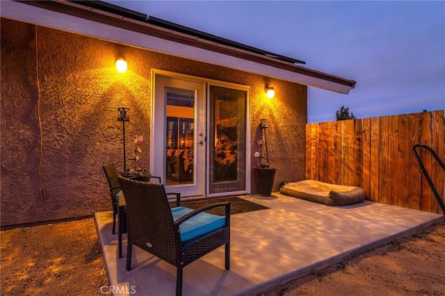 view of patio terrace at dusk