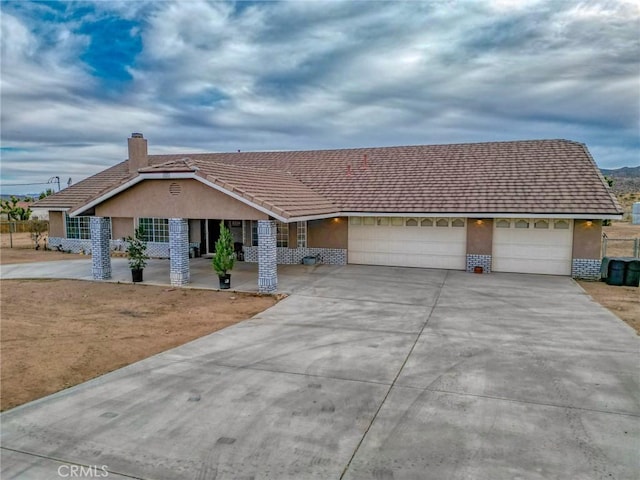 ranch-style home featuring a garage