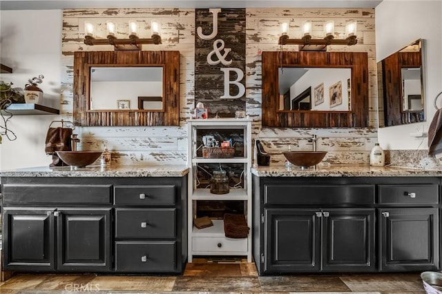 bathroom featuring wooden walls and vanity