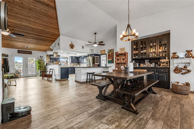 dining space featuring ceiling fan, french doors, and high vaulted ceiling