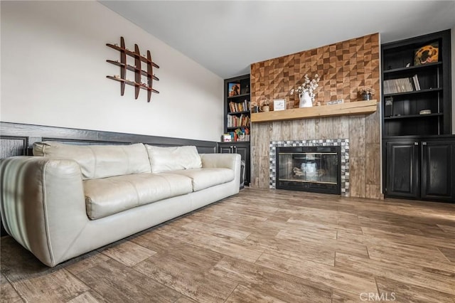 unfurnished living room featuring a fireplace and built in features