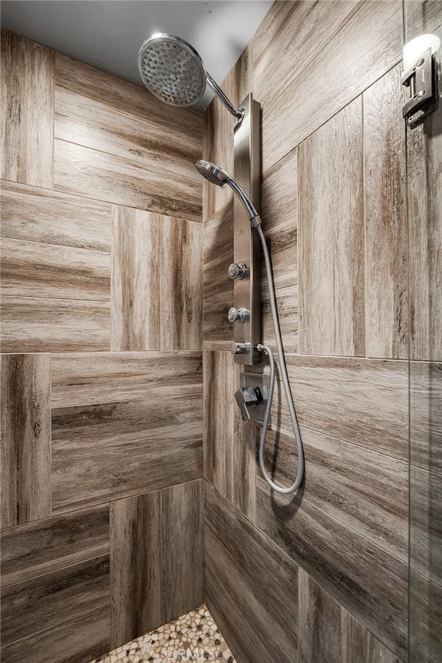 interior details with a tile shower