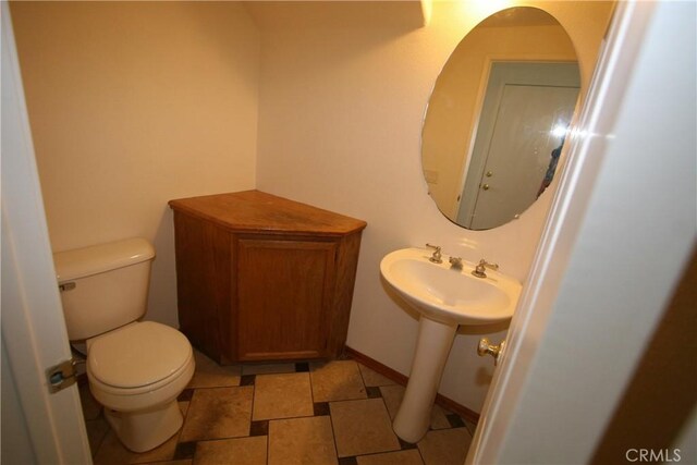 bathroom featuring sink and toilet