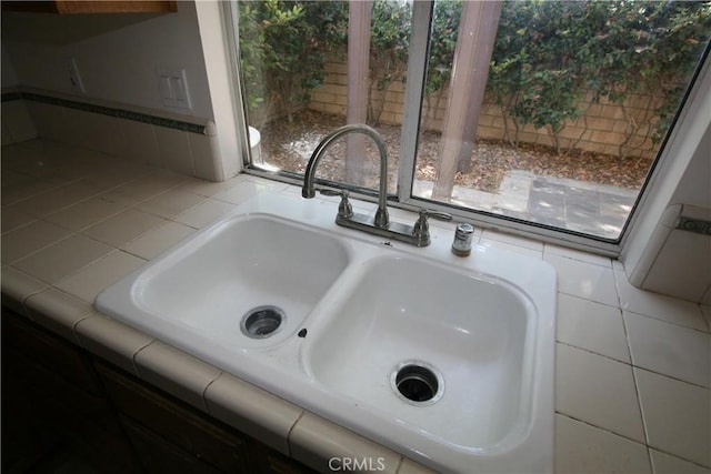 interior details with sink and tile countertops