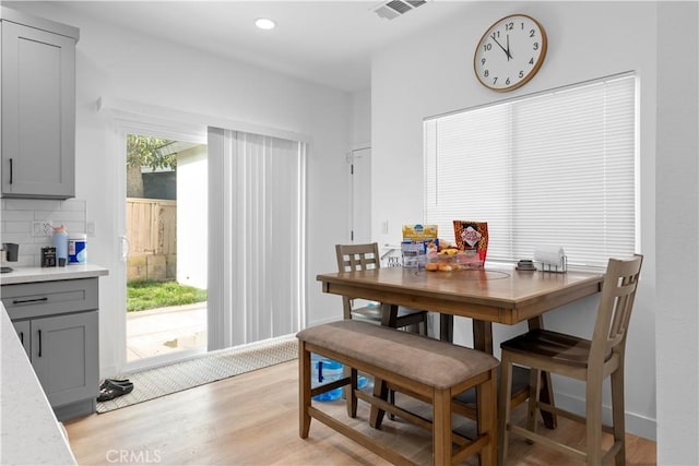 dining space with light hardwood / wood-style floors