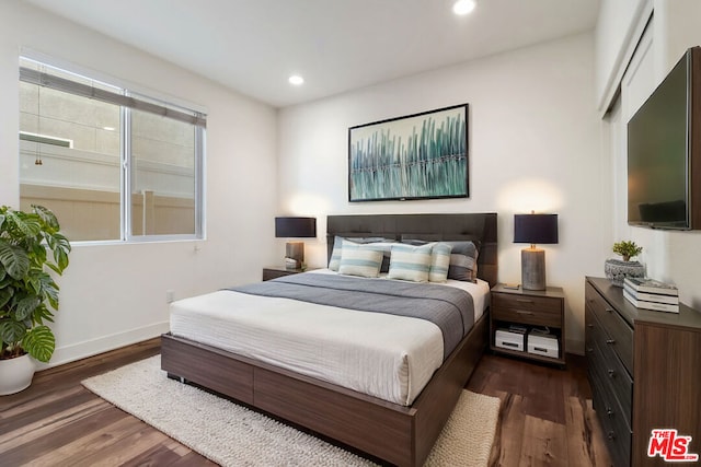 bedroom featuring dark hardwood / wood-style flooring