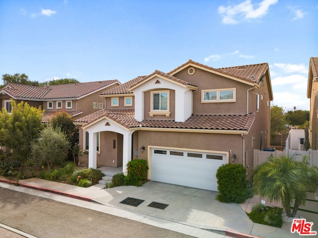 mediterranean / spanish home featuring a garage