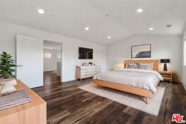 bedroom featuring dark hardwood / wood-style flooring and lofted ceiling