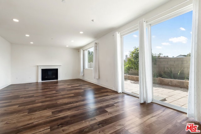 unfurnished living room featuring dark hardwood / wood-style floors