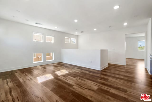 empty room with dark wood-type flooring