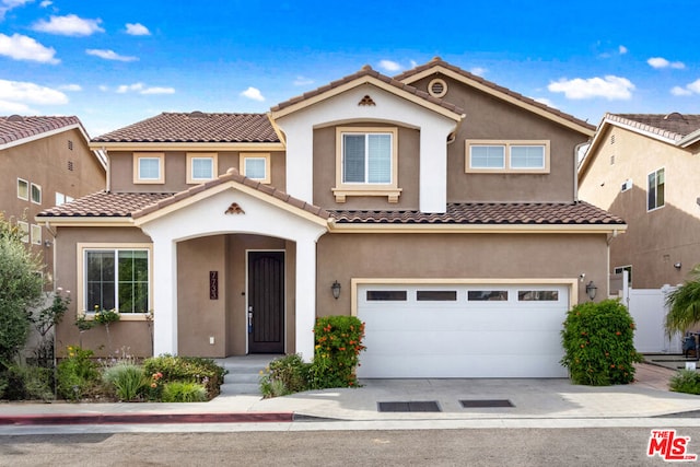 mediterranean / spanish house with a garage