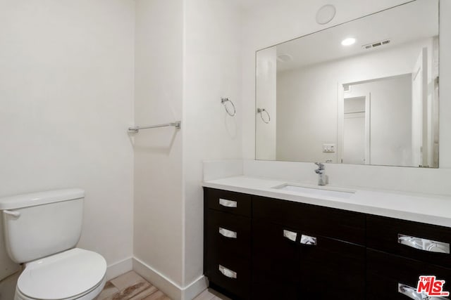 bathroom with vanity and toilet