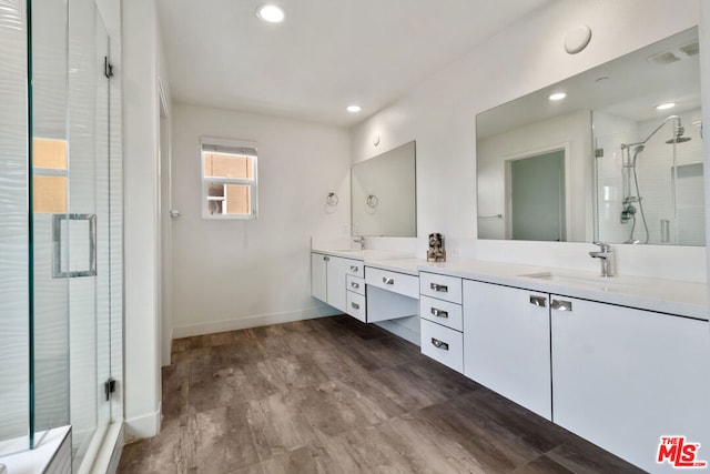 bathroom featuring vanity, a shower with door, and hardwood / wood-style floors