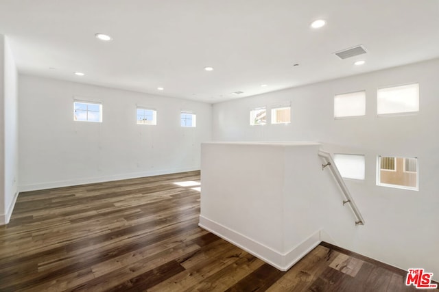 stairs featuring wood-type flooring and plenty of natural light