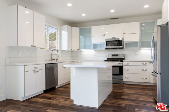 kitchen featuring stainless steel appliances, sink, and white cabinets