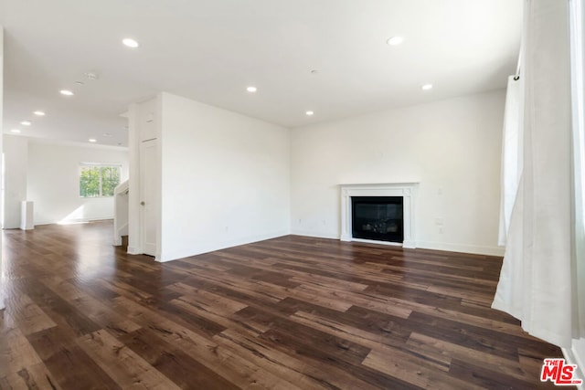 unfurnished living room with dark hardwood / wood-style floors