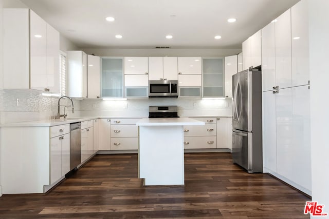 kitchen with a kitchen island, white cabinetry, and appliances with stainless steel finishes