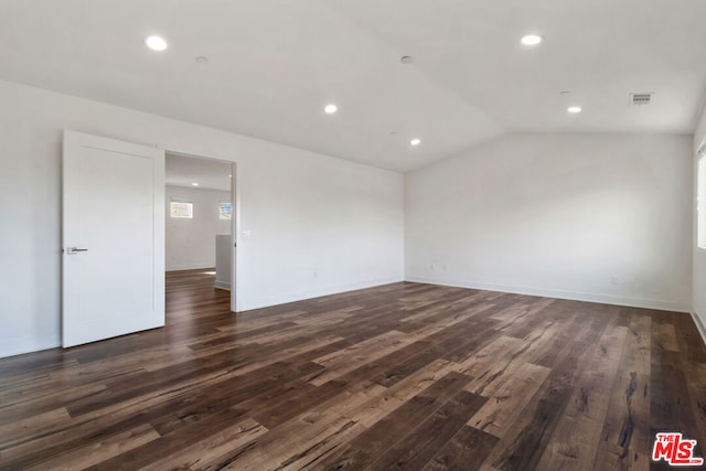 unfurnished room featuring lofted ceiling and dark hardwood / wood-style floors