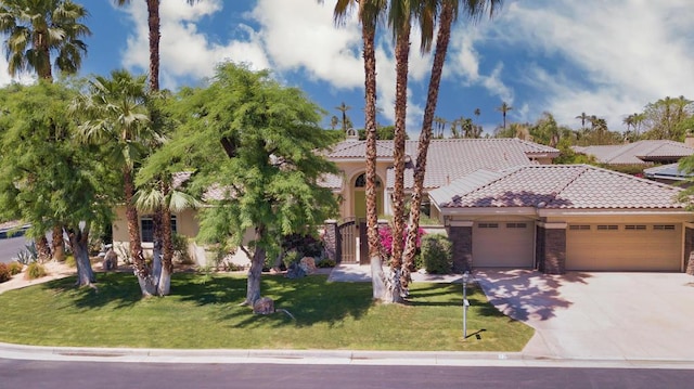 view of front of home with a garage and a front lawn