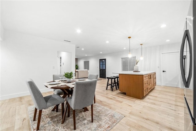 dining area featuring recessed lighting, light wood-type flooring, and baseboards