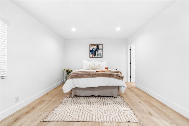 bedroom with light wood finished floors, recessed lighting, and baseboards