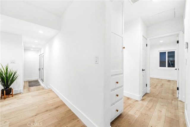 hallway featuring light wood-style flooring, recessed lighting, and baseboards