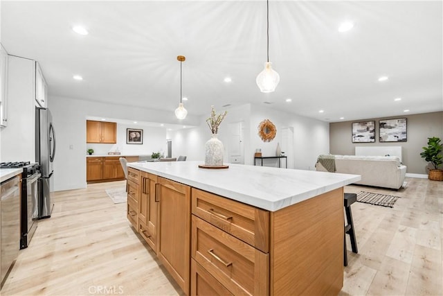 kitchen featuring a kitchen island, range with gas cooktop, light countertops, recessed lighting, and light wood-style flooring