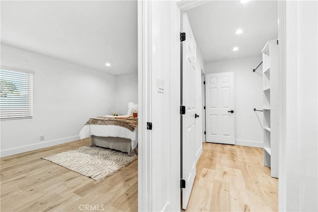 interior space featuring recessed lighting, light wood-style flooring, and baseboards