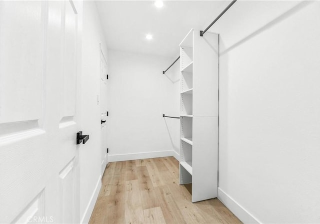 walk in closet featuring light hardwood / wood-style flooring