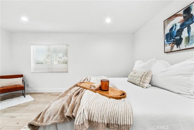 bedroom with recessed lighting, wood finished floors, and baseboards