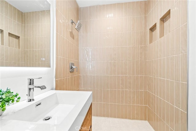 bathroom with vanity and tiled shower