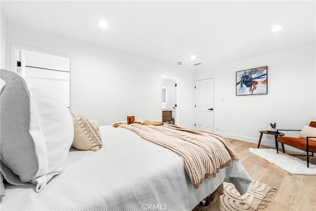 bedroom featuring light wood finished floors, recessed lighting, and baseboards