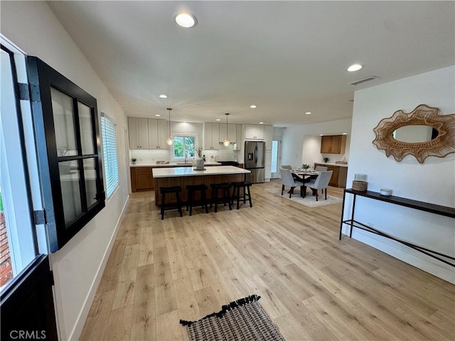 dining area featuring sink and light hardwood / wood-style flooring