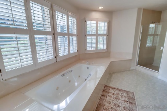 bathroom with separate shower and tub