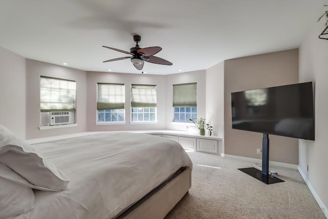 carpeted bedroom featuring ceiling fan, multiple windows, and cooling unit