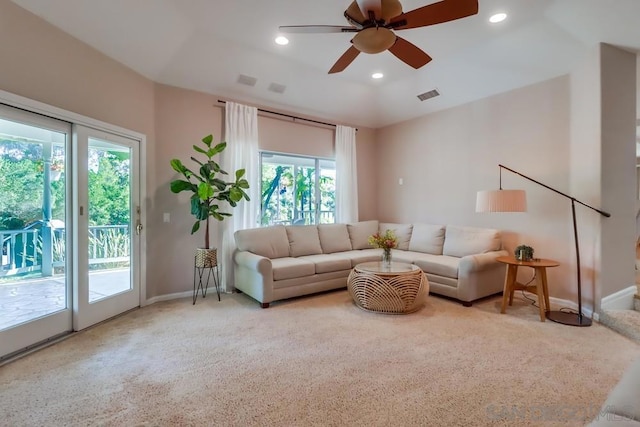 carpeted living room featuring ceiling fan