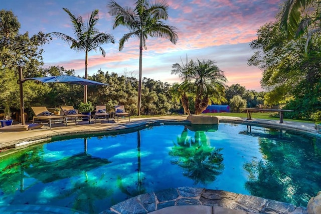 view of pool at dusk