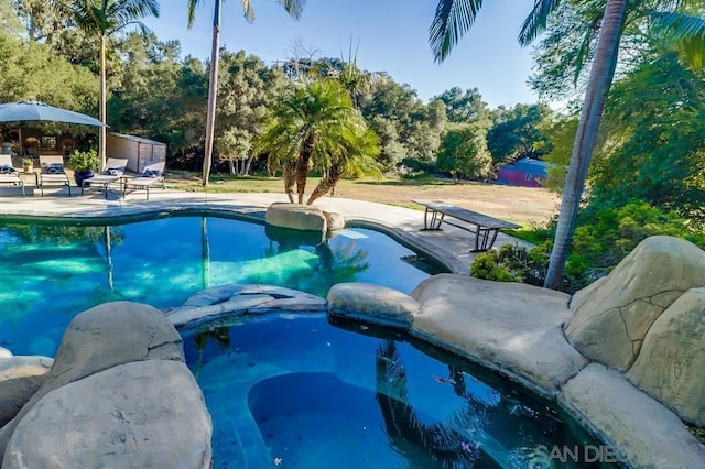 view of swimming pool featuring a patio area