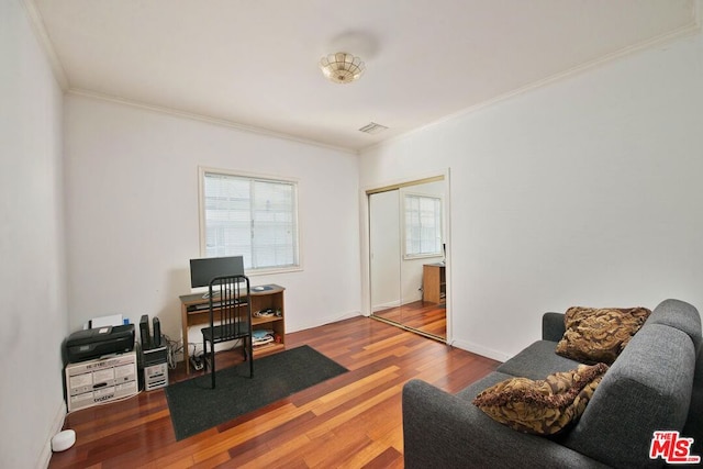 office with hardwood / wood-style floors and crown molding