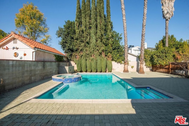 view of pool featuring an in ground hot tub and a patio