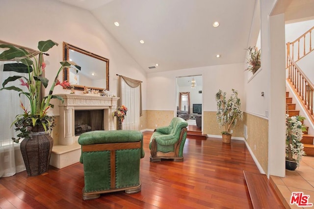 sitting room featuring hardwood / wood-style floors and lofted ceiling